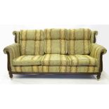 A three seat showwood framed sofa, in th