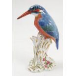 A Royal Worcester model, Kingfisher, on a gilt and white stump decorated with flowers, model