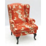 A Georgian style wing armchair, raised o