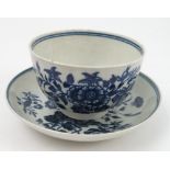 A Worcester first period tea bowl and sauce, decorated in the blue and white three flowers pattern