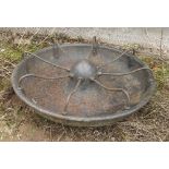 A circular cast iron pig feeder, diamete