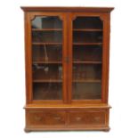 An Edwardian walnut glazed cabinet, the