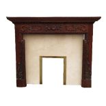 An oak fireplace, with carved swags and