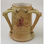 A Royal Worcester blush ivory three handled loving mug, the handles modelled as deer antlers, with