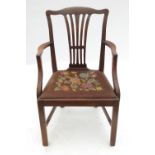 A mahogany armchair, with outswept arms