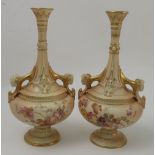 A pair of Royal Worcester blush ivory vases, decorated with floral sprays to rams mask handles,