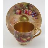 A Royal Worcester cabinet cup and saucer, the saucer and exterior of cup hand painted with fruit