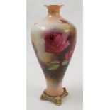 A Royal Worcester Hadley ware vase, decorated with red roses by M Blake, raised on four feet,