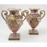 A pair of 19th century Derby porcelain pedestal vases, the body decorated in the Imari style with