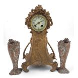 An Art Nouveau metal clock garniture, th