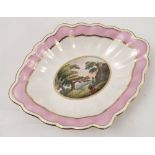A 19th century Derby porcelain oval dish, painted with figures on a path in a landscape, with pink