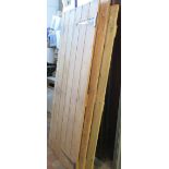 Three pine doors, one with post aperture