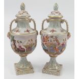 A pair of Capodimonte porcelain covered vases, of urn form, with embossed decoration, raised on a