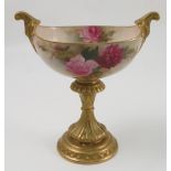 A Royal Worcester centre piece, of oval form, decorated with red and pink roses by E M Fildes,