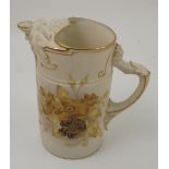 A Royal Worcester ivory jug, of cylindrical form, with lion mask spout and paw moulded handle,