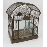 A brass and glass Oriental style bird cage, with fan top and hanging loop, with ceramic feeders,