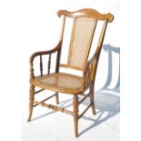 A 19th century cane seated mahogany armchair,