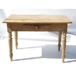 A 19th century pine side table, raised on turned legs,