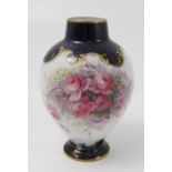 A Royal Worcester vase, decorated with flowers by Earnest Phillips, to blue and gilt borders,