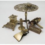 A collection of brass ware to include a pierced trivet, an inkwell, letter clip, a desk calendar,