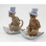 Two early 20th century Continental porcelain novelty chamber sticks, modelled as seated monkeys,