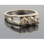 A three stone diamond ring, in 18ct white gold, London 1975,