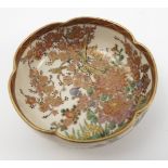 A Satsuma pottery bowl, with shaped edge, decorated with flowering prunus and other flowers, crazed,