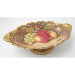 A Royal Worcester oval tazza, hand painted with fruit to a mossy ground by H Ayrton,