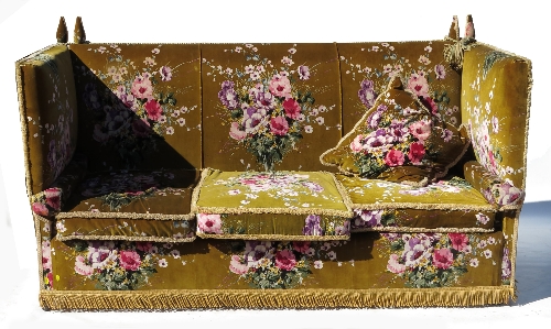 A Knoll settee, the upholstery of pink and purple floral design to a green ground,