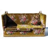 A Knoll settee, the upholstery of pink and purple floral design to a green ground,