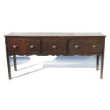 A 19th century oak dresser base, fitted three deep frieze drawers, raised on square legs,