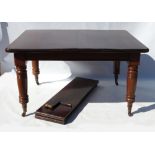 A late Victorian mahogany extending dining table, of rectangular form, raised on four turned legs,