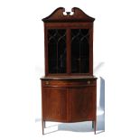 An Edwardian mahogany display cabinet, with astragal glazed doors below a swan neck frame,