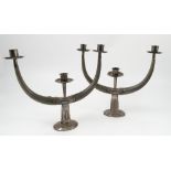 A pair of Malaysian white metal and horn candle sticks,