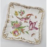 A late 18th/early 19th century Chelsea porcelain square dish, decorated with a fabulous bird,