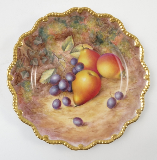A Royal Worcester cabinet plate, decorated with fruit to a mossy background by H Ayrton,