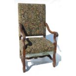 A 19th century style upholstered armchair, with outswept carved arms,