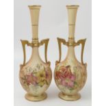 A pair of Royal Worcester blush ivory vases, with reeded bodies decorated with flowers,