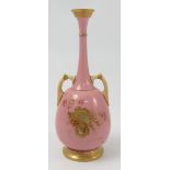 A Royal Worcester pink ground vase, decorated in gilt with foliage, shape number 857,