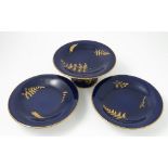 A Royal Worcester comport and two tazzas, decorated with foliage to a blue ground,