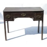 An Antique oak low boy, fitted with a central drawer flanked by two short drawers,