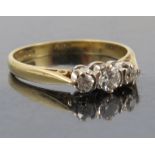 A three stone diamond 18ct gold ring, the graduated diamonds of approximately 0.