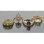 A collection of four 9ct gold dress rings, QVC, set with gemstones and diamonds to include peridot,