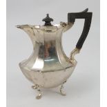 A silver hot water jug, of faceted oval baluster form, raised on four scroll legs, London 1896,