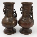 A pair of Oriental bronze vases, of baluster form, decorated with embossed birds,