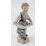 A 19th century Meissen model, of a girl carrying flowers in her apron, decorated in blue and gold,