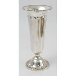 A silver vase, with bead edge, fluted tapering body,