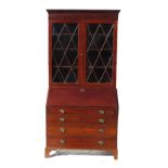 A 19th century mahogany bureau bookcase, the glazed upper section opening to reveal shelves,