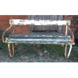 A garden seat, with scrolling metal ends and wooden slats,