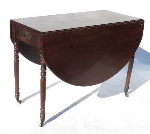 A 19th century mahogany Pembroke table, with oval flaps and fitted with a frieze drawer,